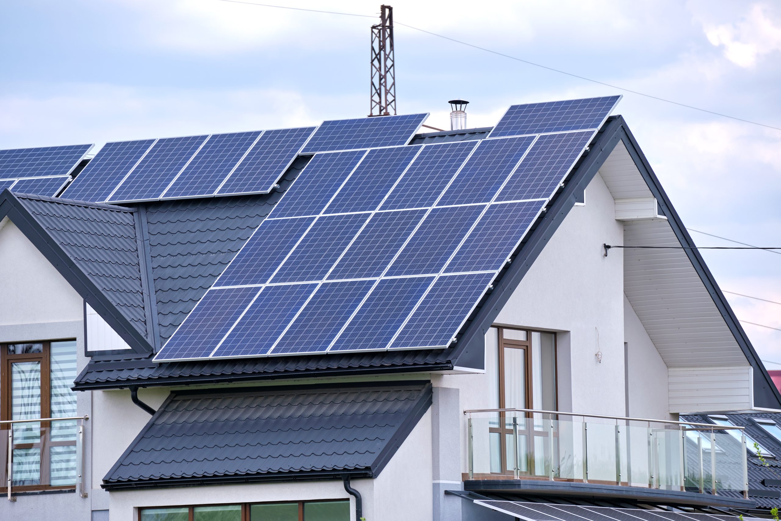 Residential house with rooftop covered with solar photovoltaic panels for producing of clean ecological electrical energy in suburban rural area. Concept of autonomous home house-with-solar-panels-on-the-roof-2026-03-17-07-23-48-utc